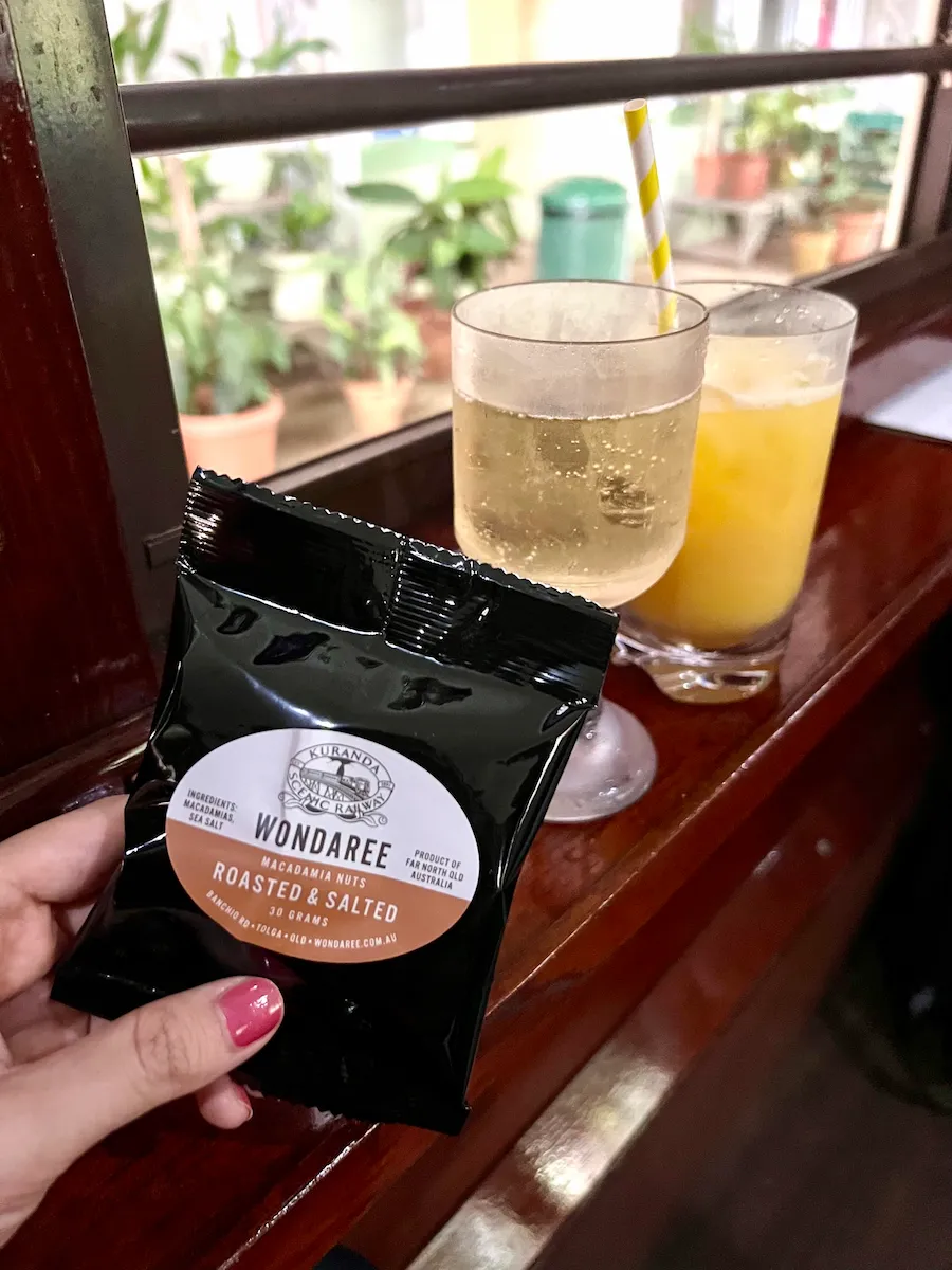 Drinks and macadamia nuts in Kuranda Gold Class